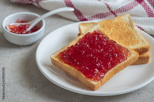 Toast bread with strawberry jam on plate