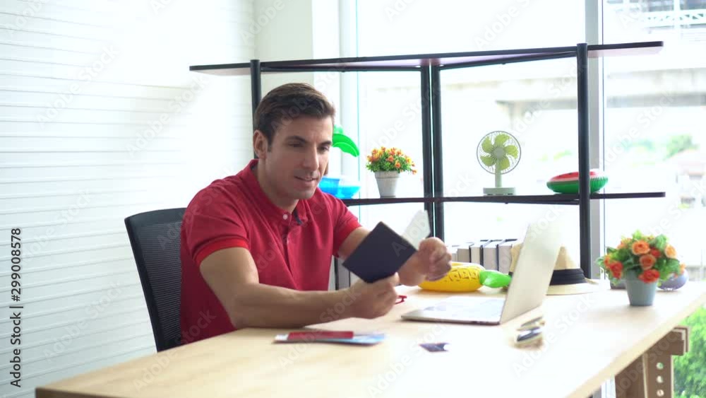 Hispanic latin man booking vacation flight online using passport Hispanic latin man booking vacation flight online using passport