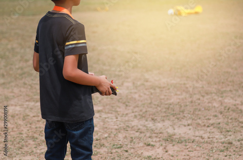 kid playing radio air control plane 