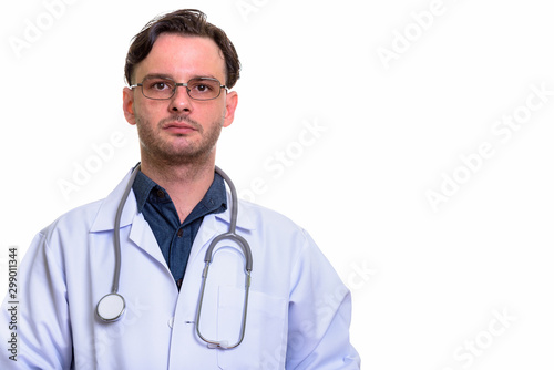 Studio shot of man doctor with eyeglasses looking at camera