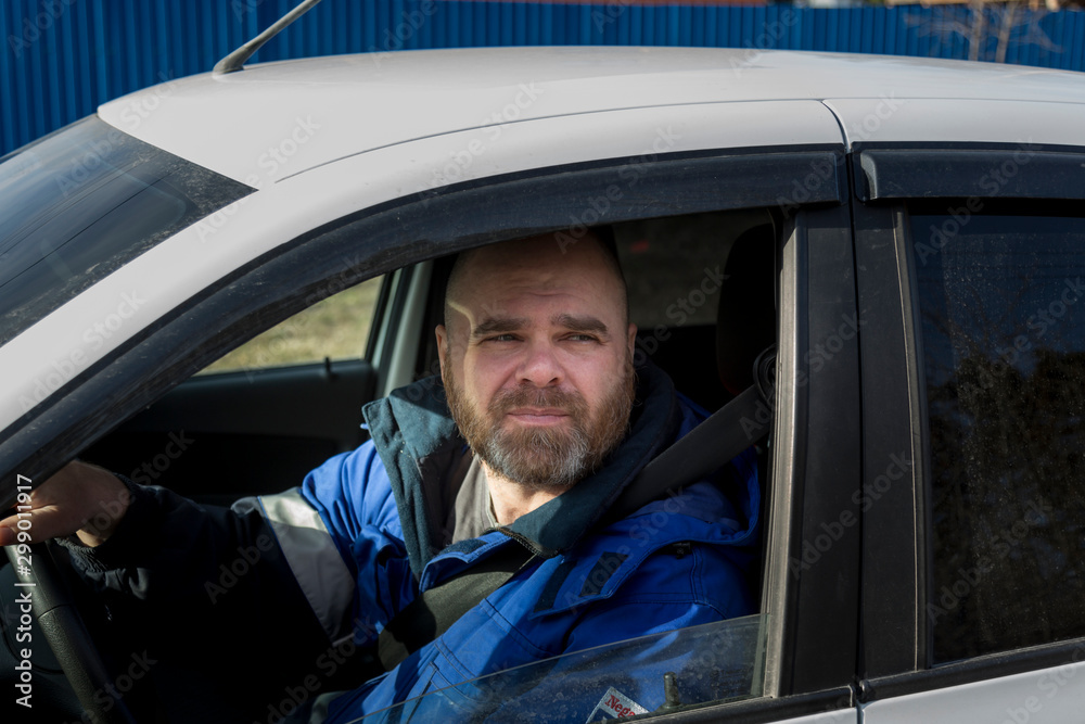 Portrait of a man with a beard driving a car Portrait of a man with a beard driving a car