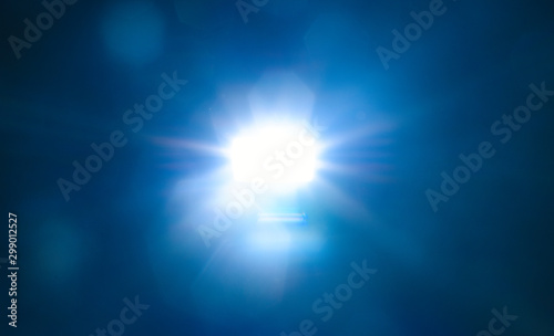 Blue light flare special effect  on black background   concert lighting .