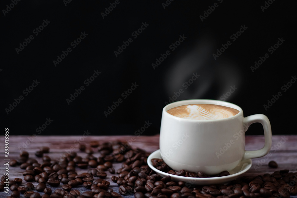 White coffee mugs on a wooden table with coffee beans on the floor. White coffee mugs on a wooden table with coffee beans on the floor.