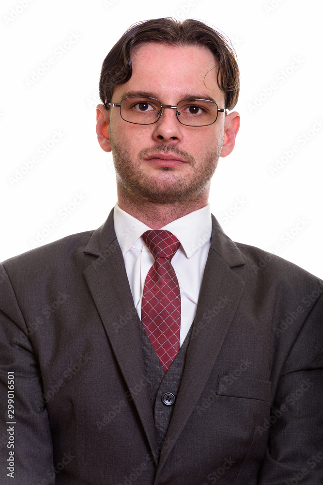 Studio shot of young businessman in suit looking at camera Studio shot of young businessman in suit looking at camera