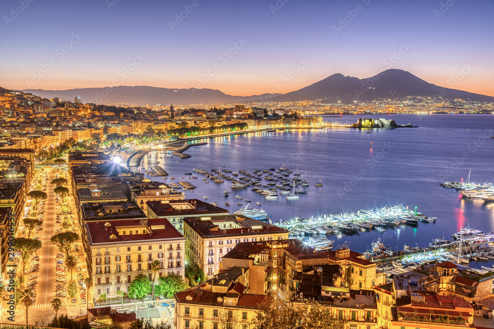 Fototapeta premium The city of Naples in Italy with Mount Vesuvius before sunrise
