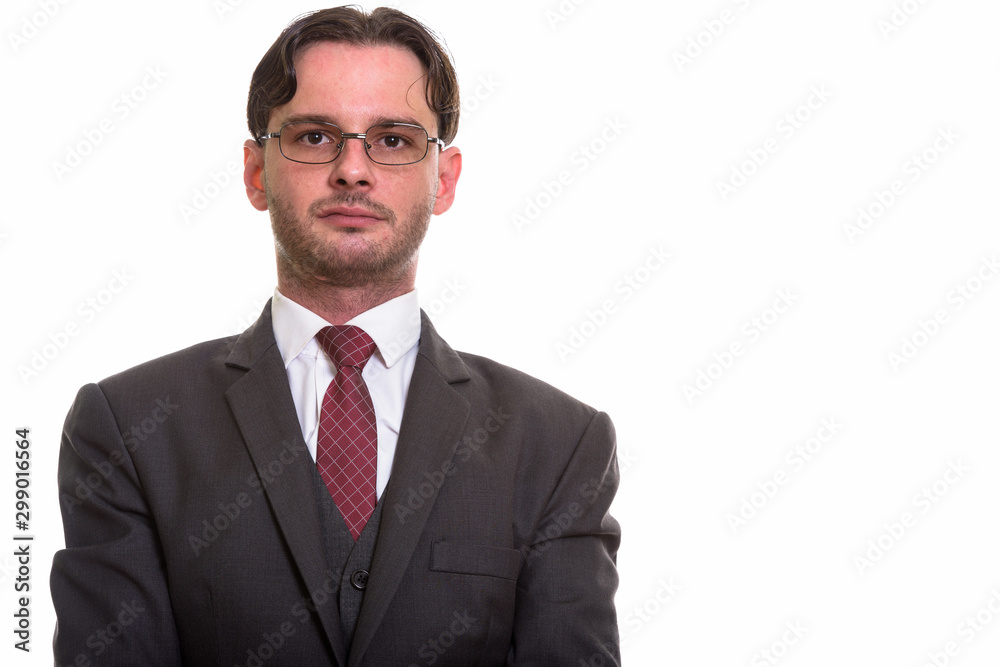 Studio shot of young businessman in suit wearing eyeglasses Studio shot of young businessman in suit wearing eyeglasses