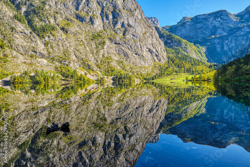 The lovely Obersee in the Bavarian Alps with a reflection of the mountains in the water photo