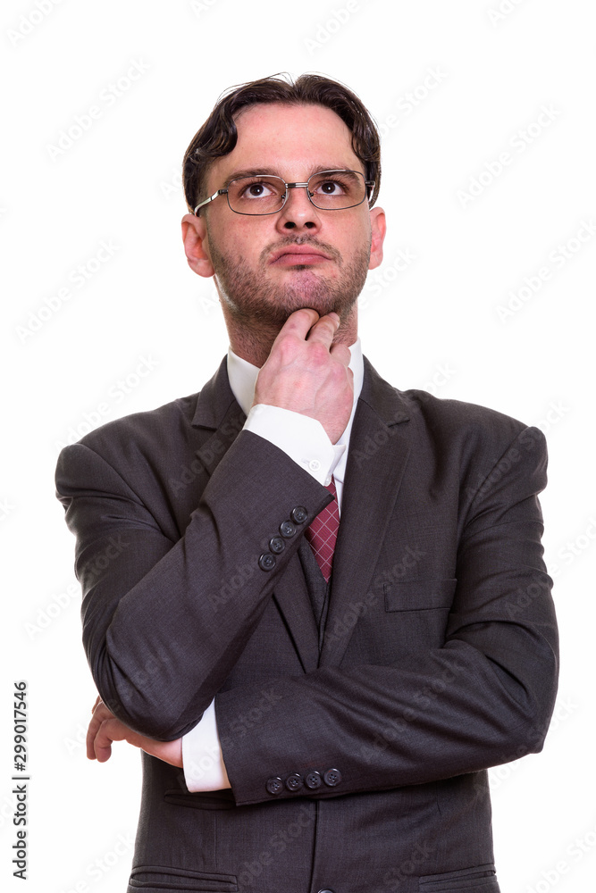Close up of young businessman thinking while looking up Close up of young businessman thinking while looking up