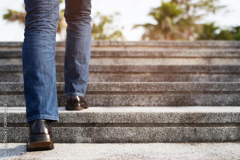 Close up legs shoes of young business man One person walking stepping going up the stairs in modern city, go up, success, grow up. stairway