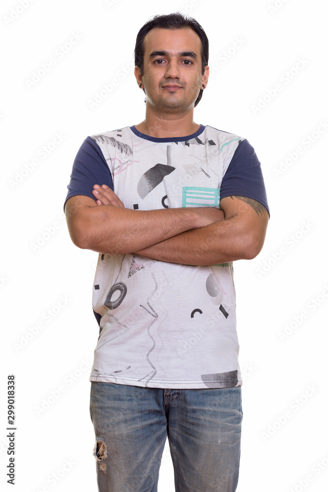 Studio shot of Persian man standing with arms crossed Studio shot of Persian man standing with arms crossed
