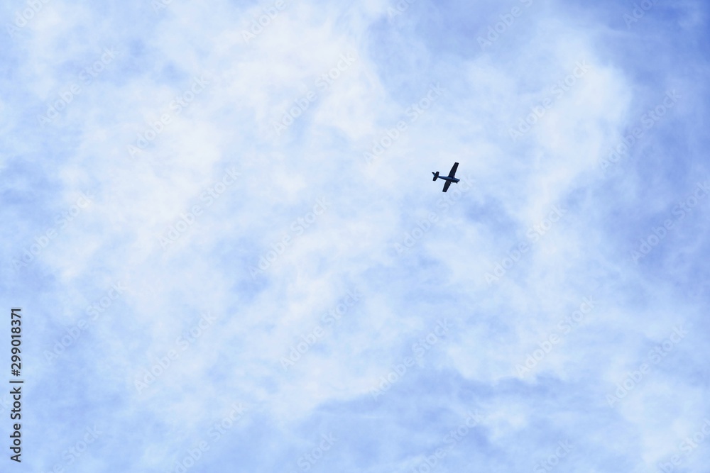 空を舞う小型飛行機のシルエット 空を舞う小型飛行機のシルエット