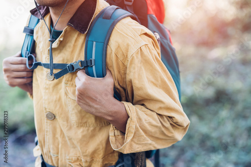 close up hand holding backpack man hiking traveling on forest in travel Lifestyle wanderlust adventure with enjoying on nature. Tourist traveler on background valley landscape view. focus to hand.