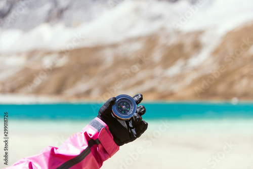 Hand traveler woman holding compass at mountain,Navigation for travel