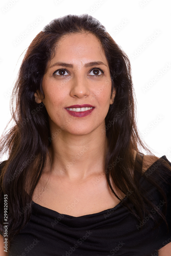Face of happy Persian woman smiling while thinking Face of happy Persian woman smiling while thinking
