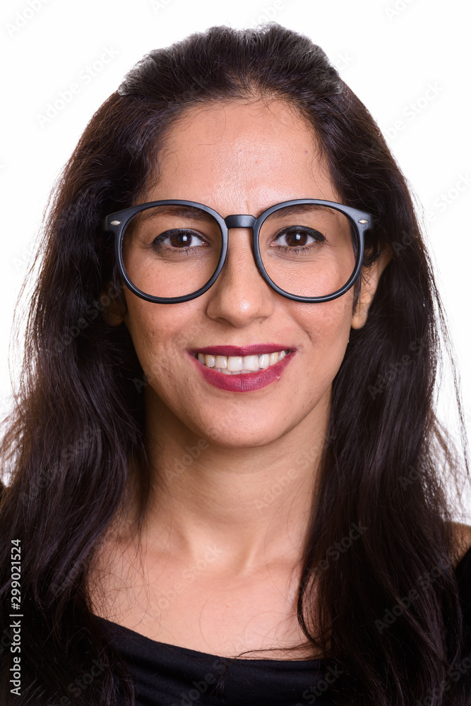 Face of happy Persian woman smiling while wearing eyeglasses Face of happy Persian woman smiling while wearing eyeglasses
