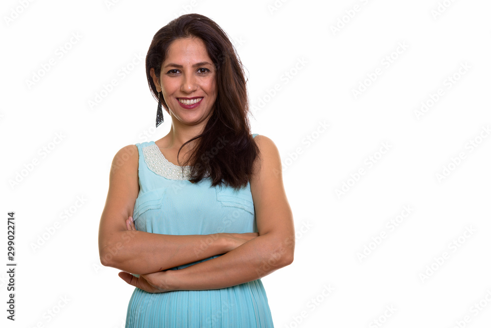Studio shot of happy Persian woman smiling with arms crossed Studio shot of happy Persian woman smiling with arms crossed