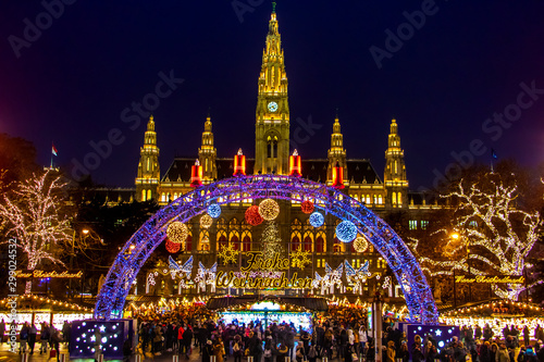 The Illuminating gate in front of the Christmas market by City hall -  Rathaus in night Vienna, Austria. photo