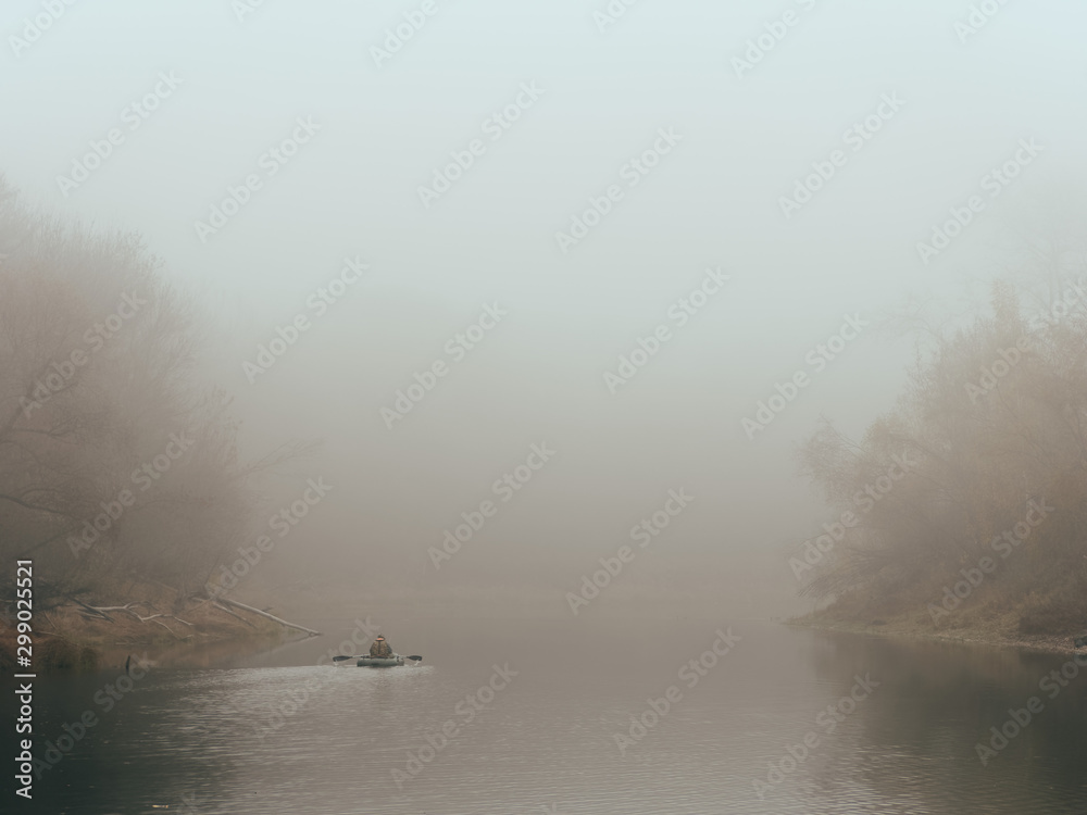 foggy morning fishermen on a boat on the water