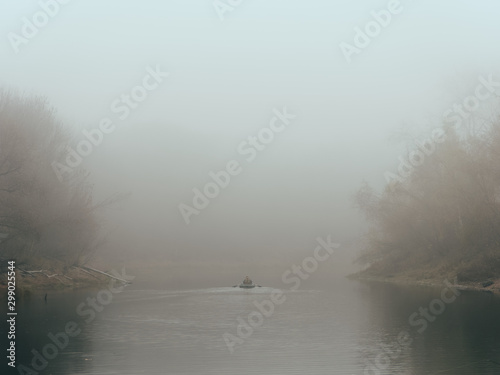 foggy morning fishermen on a boat on the water