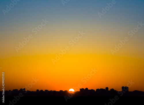 Silhouette city and building at the sunset with twilight colourful sky