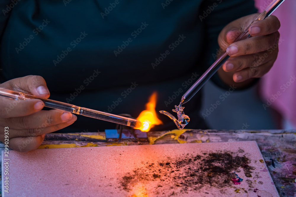 Obraz premium Asian people made hand craft grass blowing with fire blower.