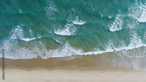 Beach on aerial drone top view with ocean waves reaching shore. © totojang1977