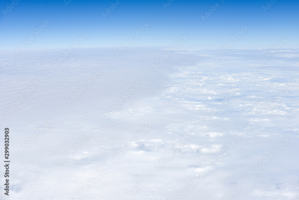 Background of View the blue sky and white clouds from the airplane window with copy space Background of View the blue sky and white clouds from the airplane window with copy space