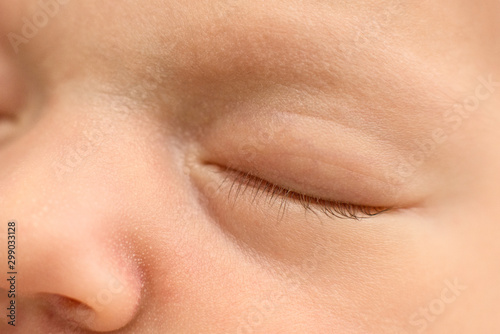  face of a sleeping newborn baby, fingers on the cheek, close up, macro, maternal care, love and family 