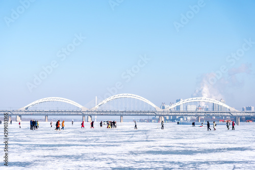 In Winter river the turns into frozen, People can walk down and arrange activities on the river in Harbin China
