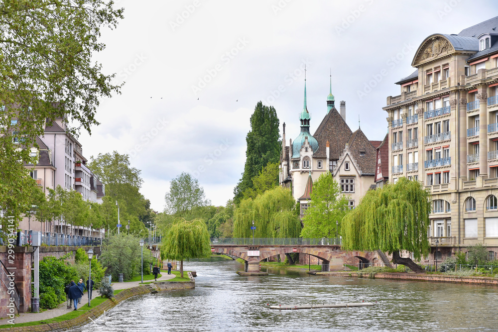 Strasbourg, France - May 2019. Traditional half-timbered houses on picturesque canals in the center old city Strasbourg. Amazing colorful houses in La Petite France, Alsace. riverbanks in Strasbourg 