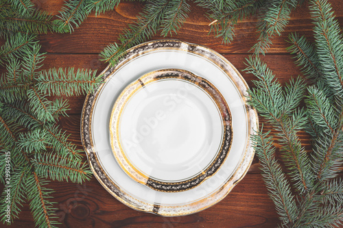 Christmas table setting with pine tree branches and decorations top view