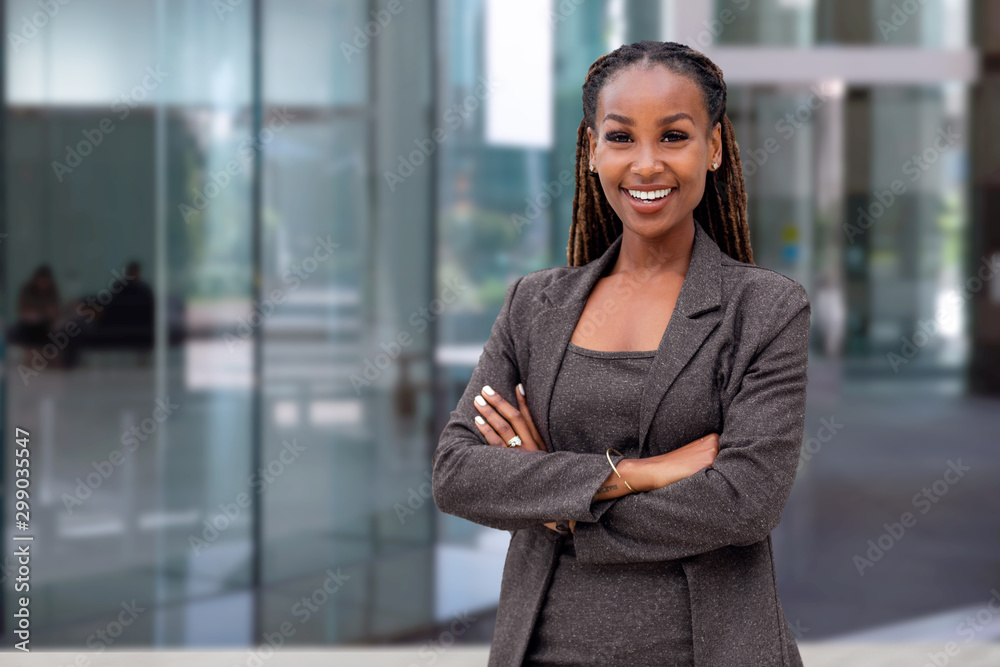 Happy African American female company leader CEO boss executive standing in front of company building Happy African American female company leader CEO boss executive standing in front of company building