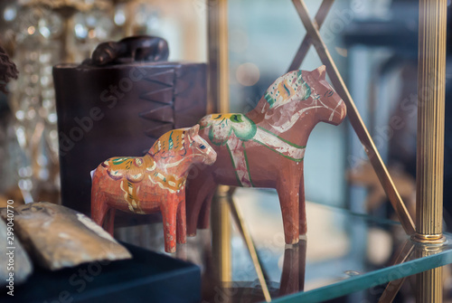 Two old dala horses on display in a swedish antique shop window in gamla stan, stockholm.