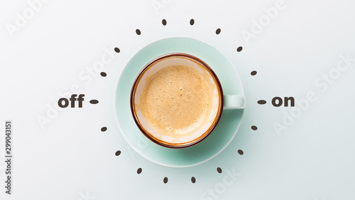 Blue cup with cappuccino over grey background