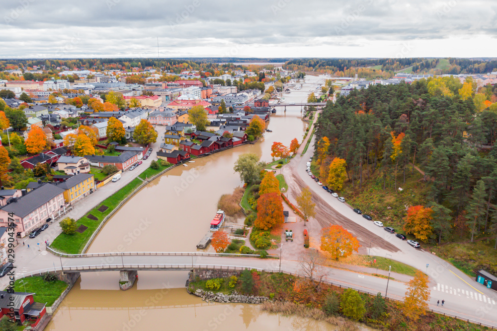 Aerial autumn view of Old town of Porvoo, Finland. Beautiful city landscape with idyllic river Porvoonjoki and old colorful wooden buildings.