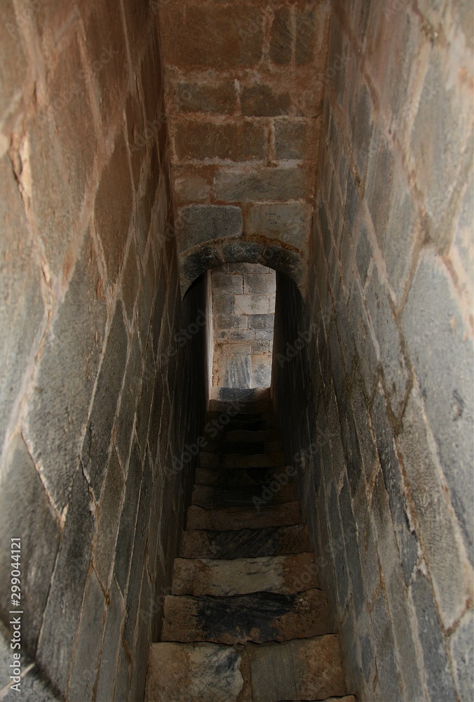 narrow corridor with stairs in an old fortress