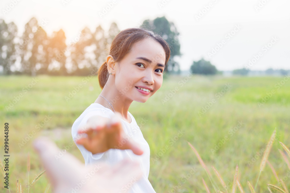 A young couple holding hands. In Nature sunrise A young couple holding hands. In Nature sunrise