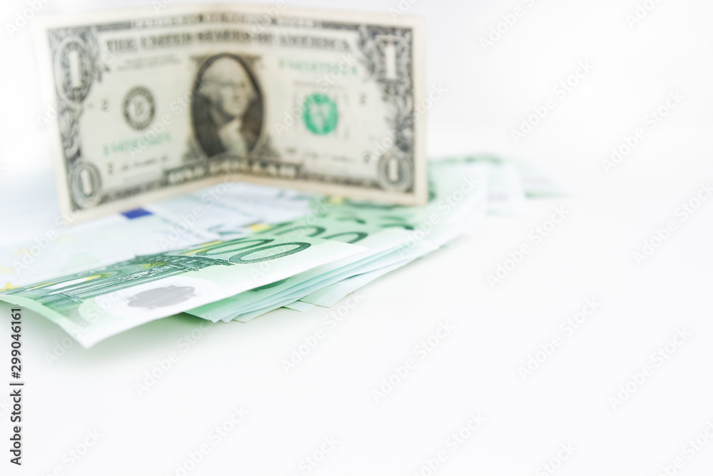 American dollar closeup of blue euro money banknotes. Money savings concept. Euro cash on white background. American dollar closeup of blue euro money banknotes. Money savings concept. Euro cash on white background.