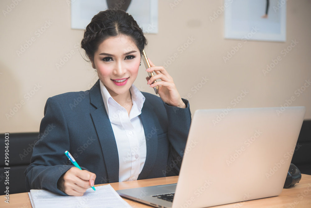 Happy young Asian woman answer phone from customer with her business online shopping at office. Happy young Asian woman answer phone from customer with her business online shopping at office.