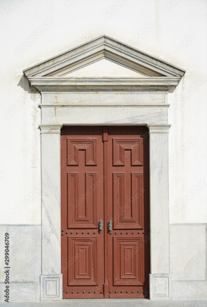 a Roman-style gate on a white wall a Roman-style gate on a white wall