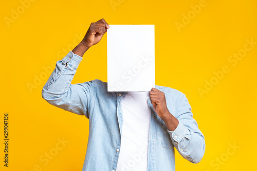 Black guy covering his face with white blank paper