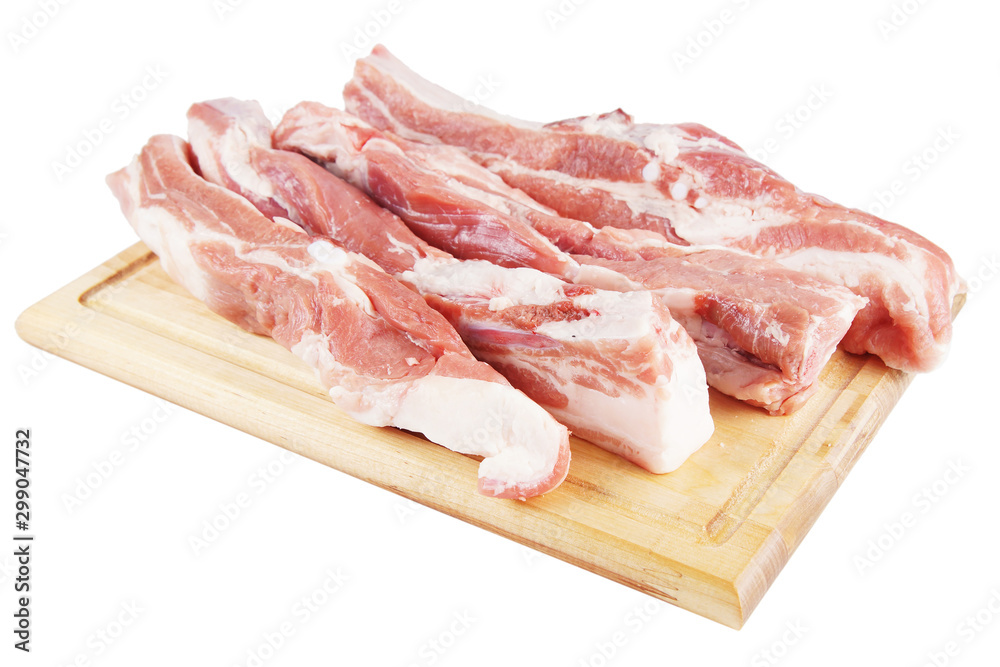 Several pieces of fresh pork on a wooden cutting board Several pieces of fresh pork on a wooden cutting board