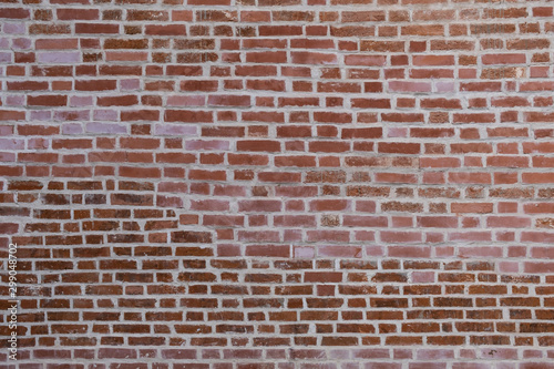 texture of old red brick wall with white seams