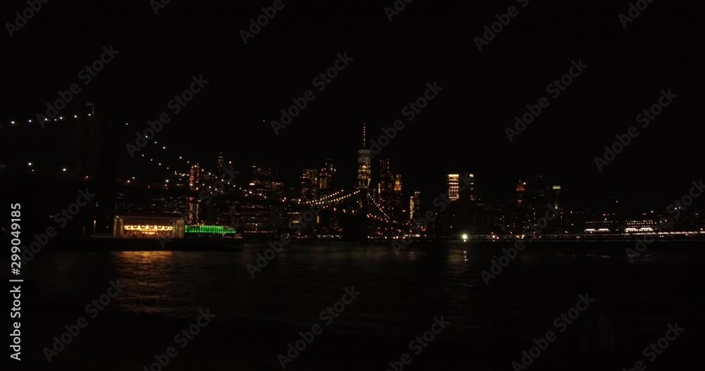 The Brooklyn Bridge with the skyscrapers of the Lower Manhattan in the background at summer night. The Brooklyn Bridge with the skyscrapers of the Lower Manhattan in the background at summer night.