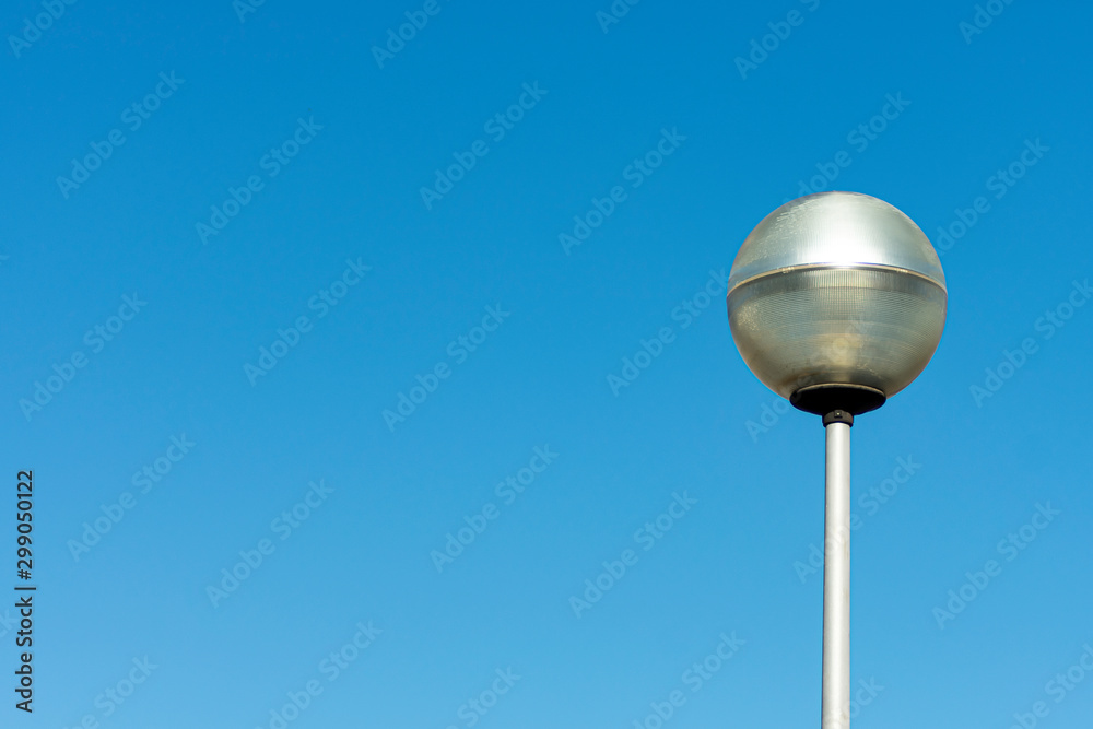 Modern lamppost of gray color and LED lighting installed in urban area Modern lamppost of gray color and LED lighting installed in urban area