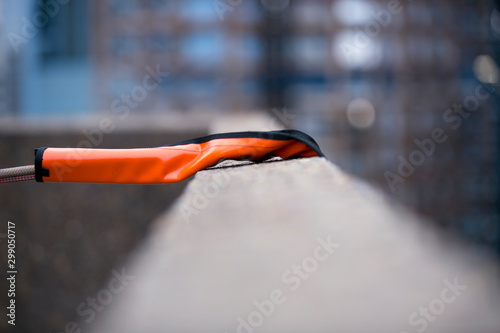 Using industry heavy duty orange safety rope protection to protecting damaging from sharp edge corner with blurry building at the back ground construction  site Sydney city CBD, Australia    