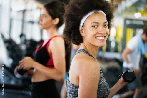 Fitness, sport, healthy and lifestyle concept. Smiling african american woman in gym