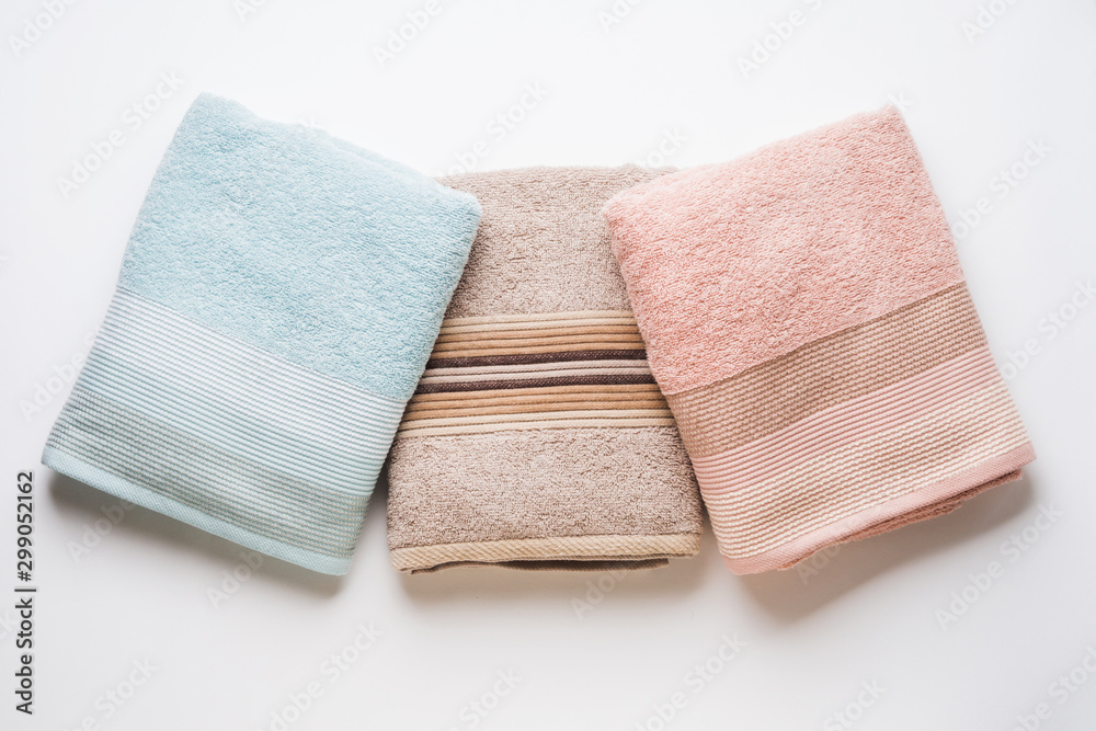 Pastel color clean folded towels on white background. Flat lay Pastel color clean folded towels on white background. Flat lay