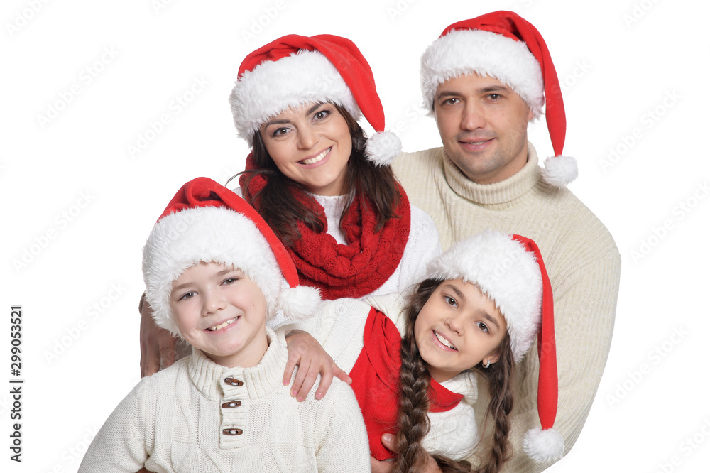 Close up portrait of family with kids in santa hats Close up portrait of family with kids in santa hats