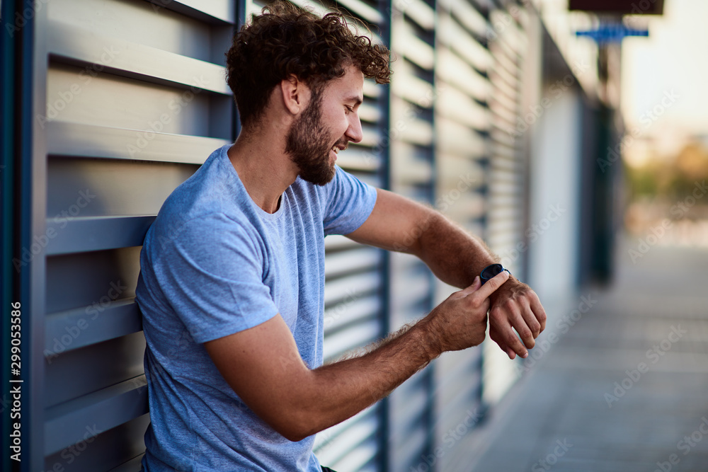 Sportsman making pause during exercising in urban area. Sportsman making pause during exercising in urban area.